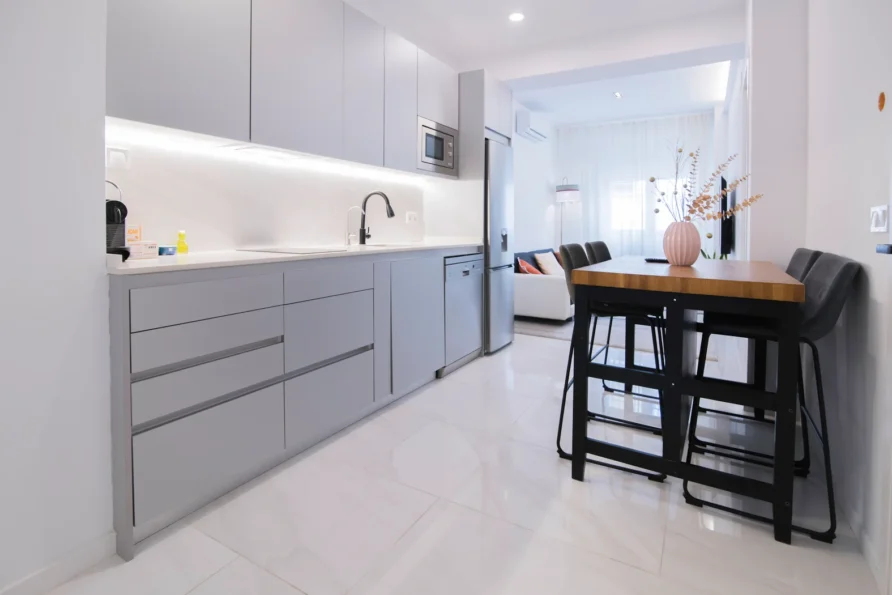 A modern kitchen with light grey cabinets