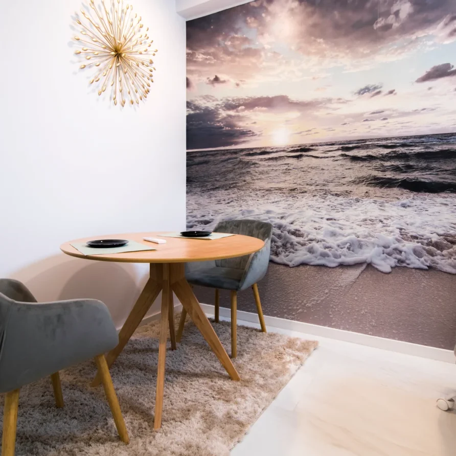Cozy dining nook with beach sunset mural and modern decor