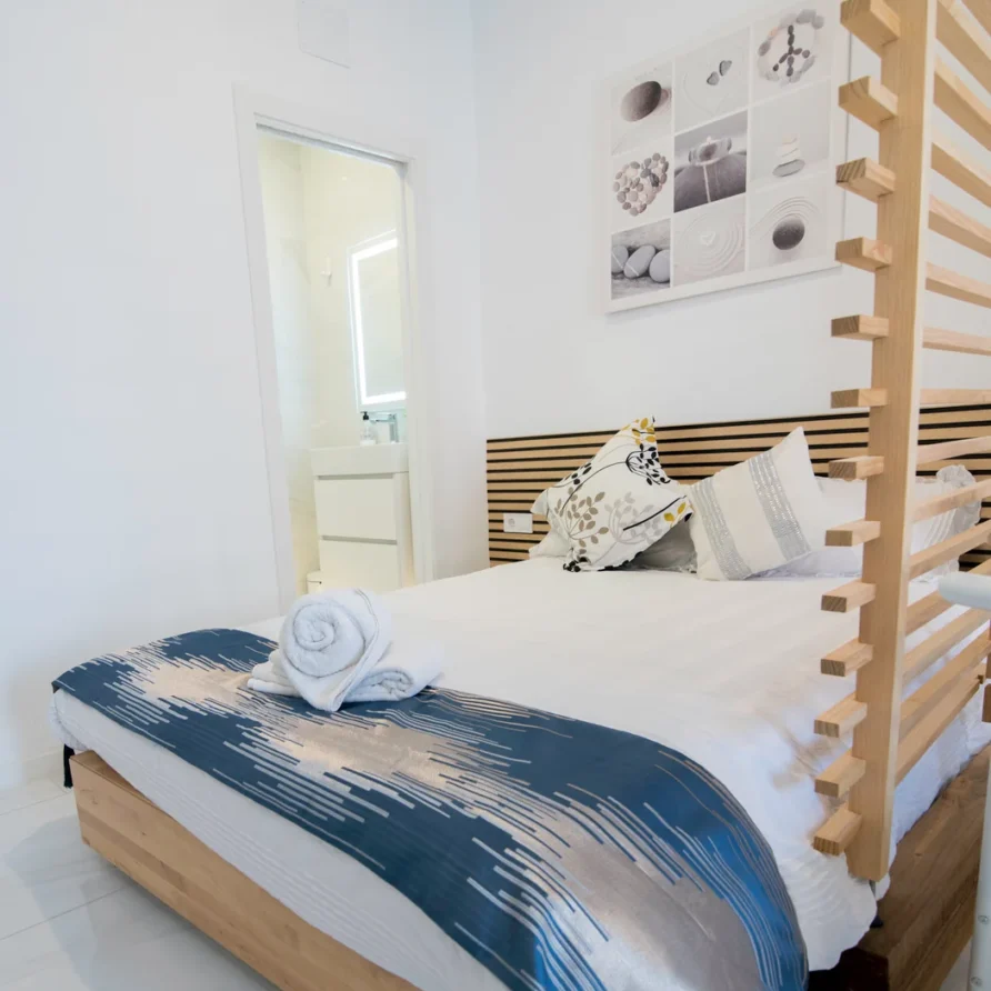 A modern bedroom with a wooden bed frame