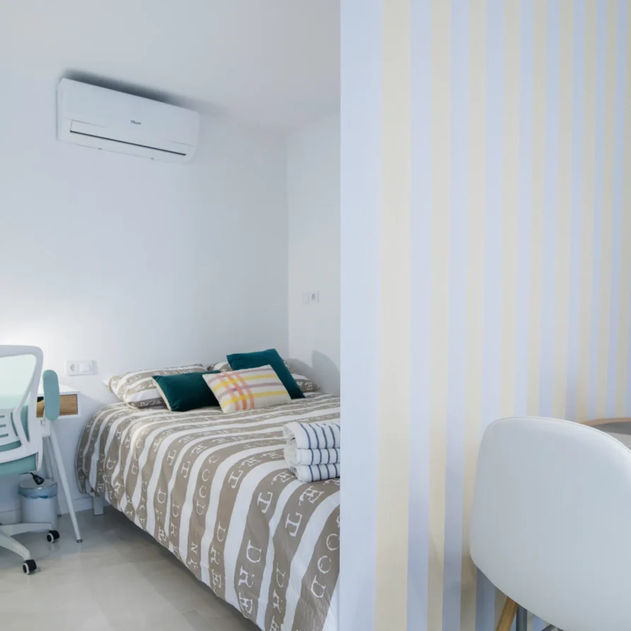 Modern minimal bedroom with striped bedspread