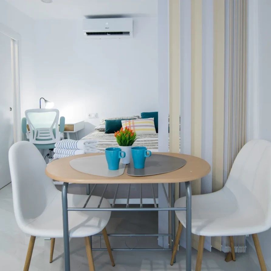 A cozy, modern studio apartment featuring a dining area