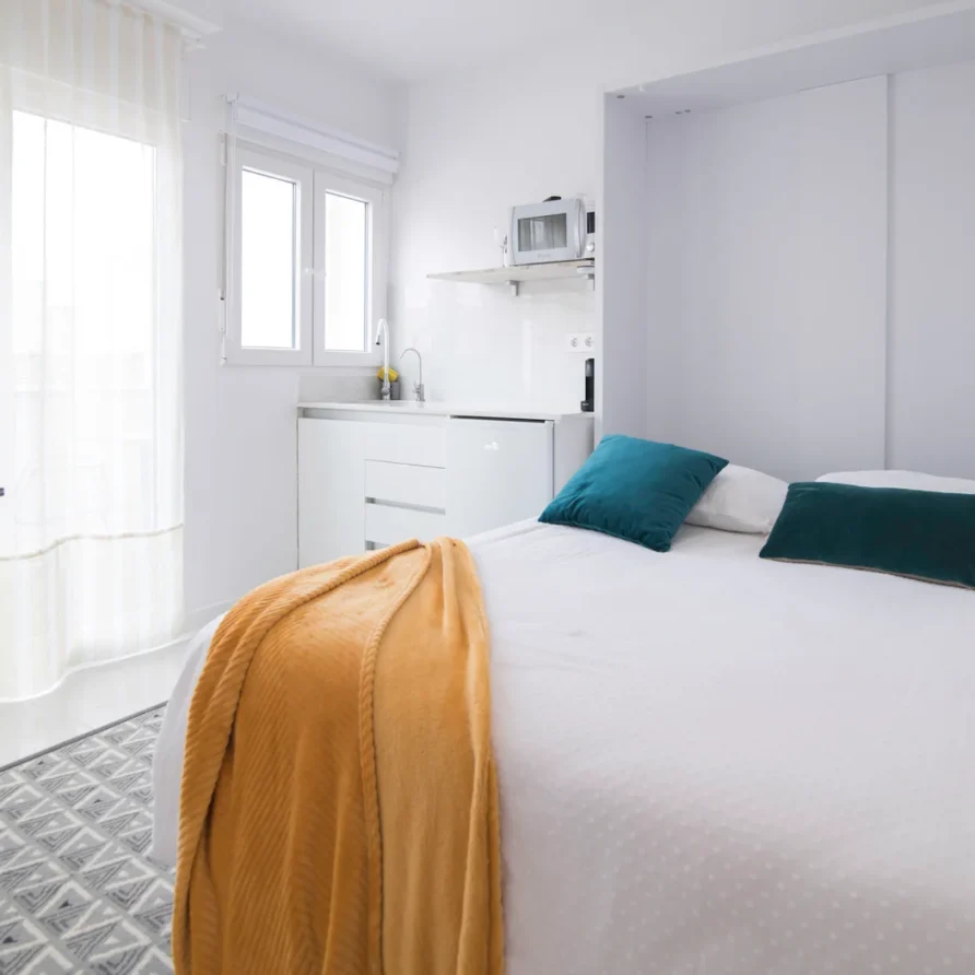 Bright minimalist bedroom with kitchenette