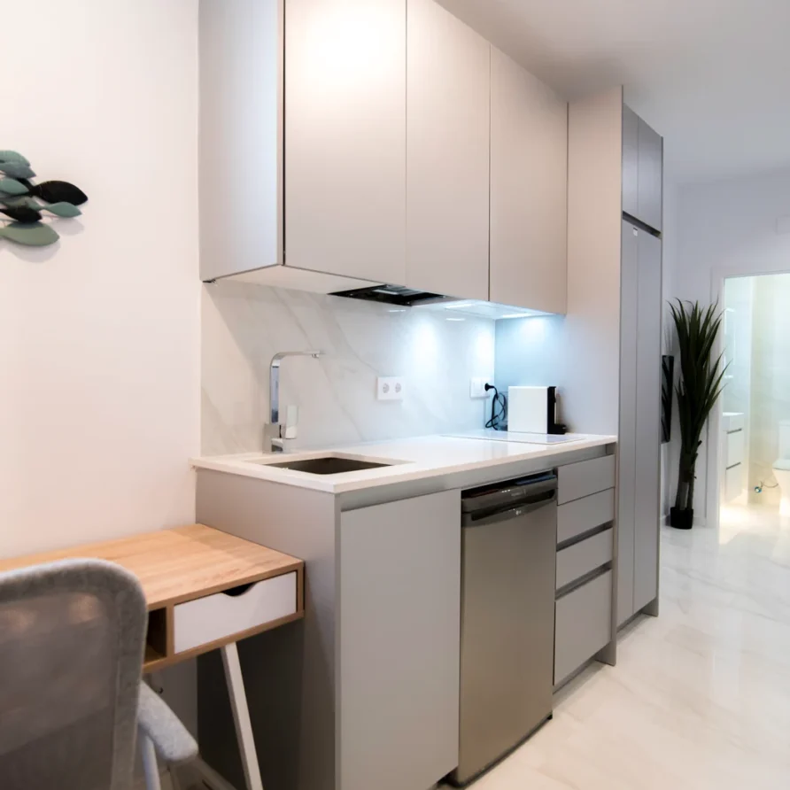 Modern small kitchen with light gray cabinets