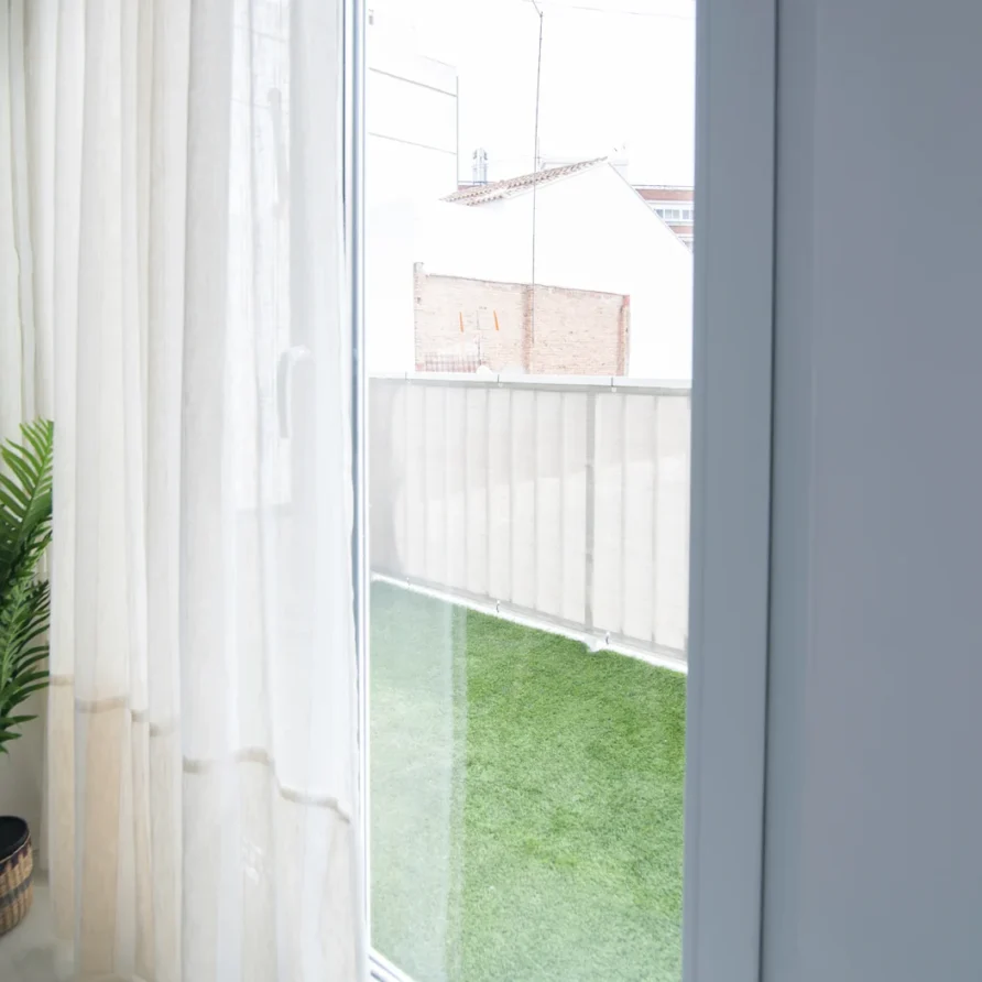 Window with white sheer curtains
