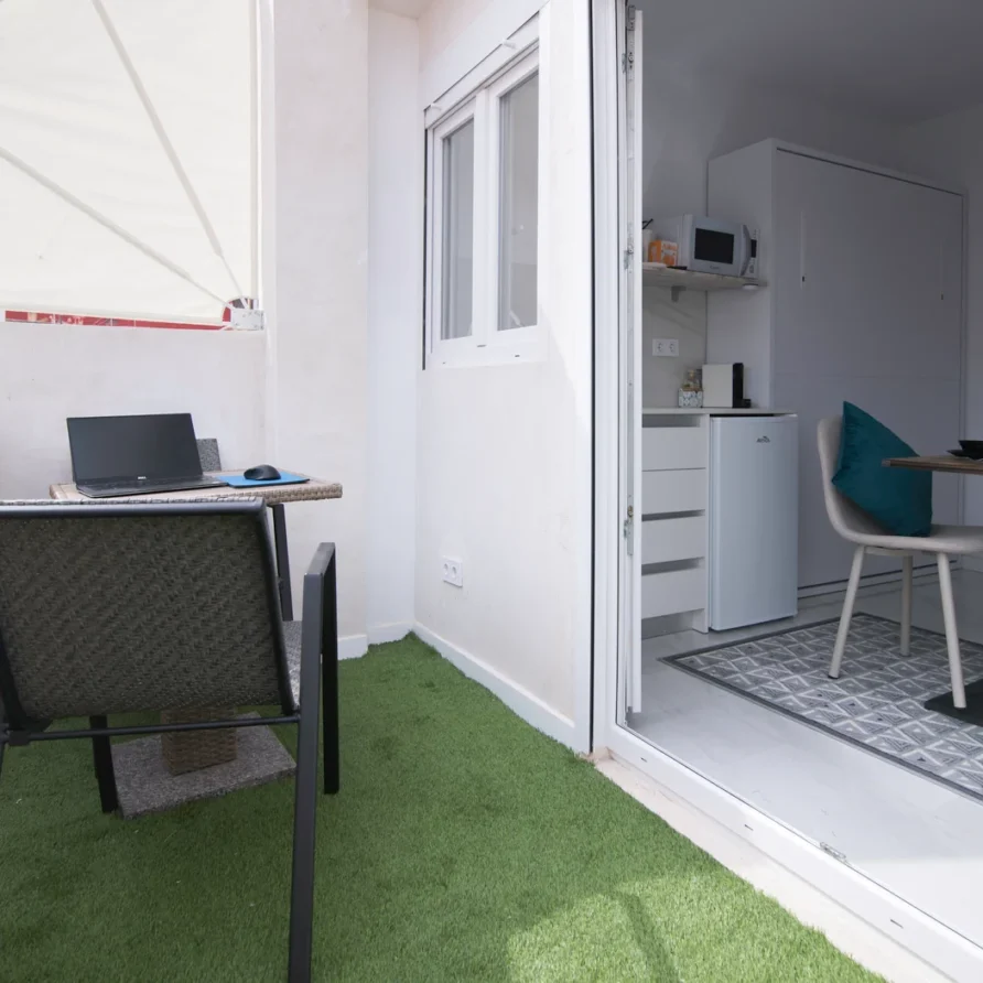 Patio with laptop by compact kitchen