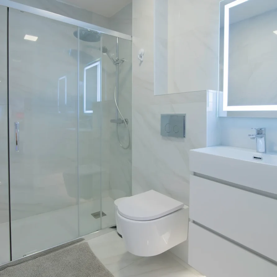 Modern bathroom with shower, toilet, vanity, and mirror