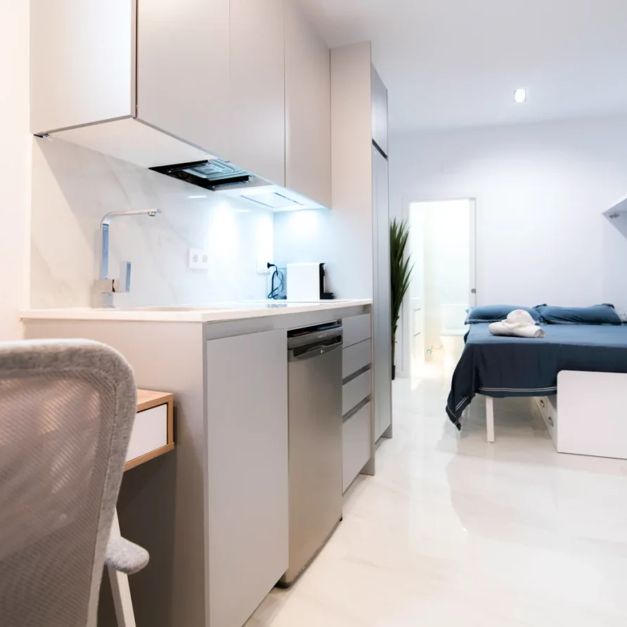 A modern studio apartment with a compact kitchen area