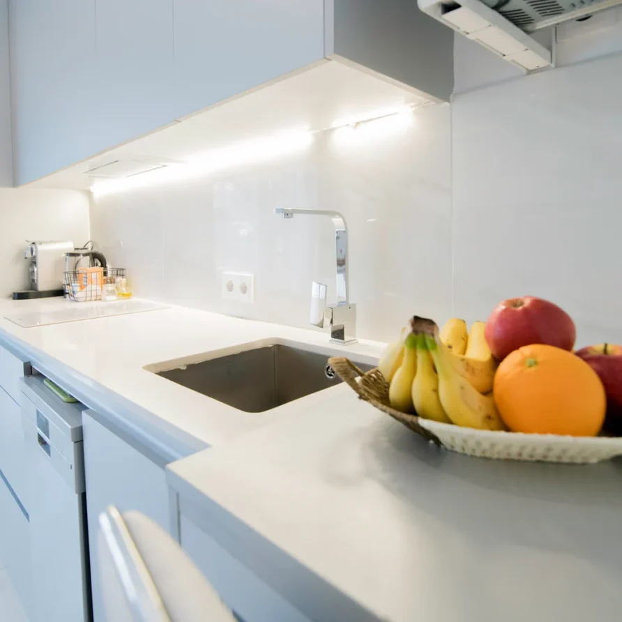 Modern white kitchen with fruit on countertop