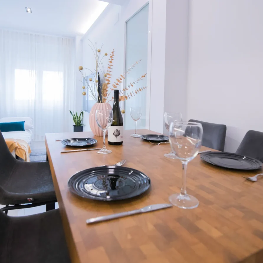 A dining table set with black plates