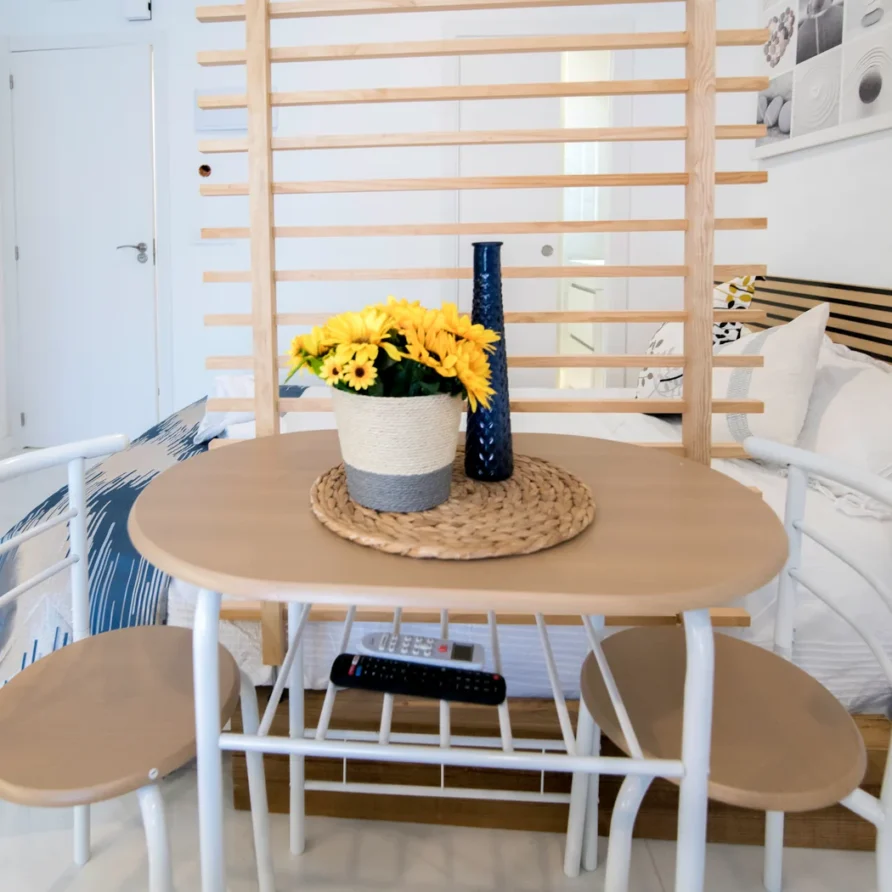 Wooden table with stools and decorative items