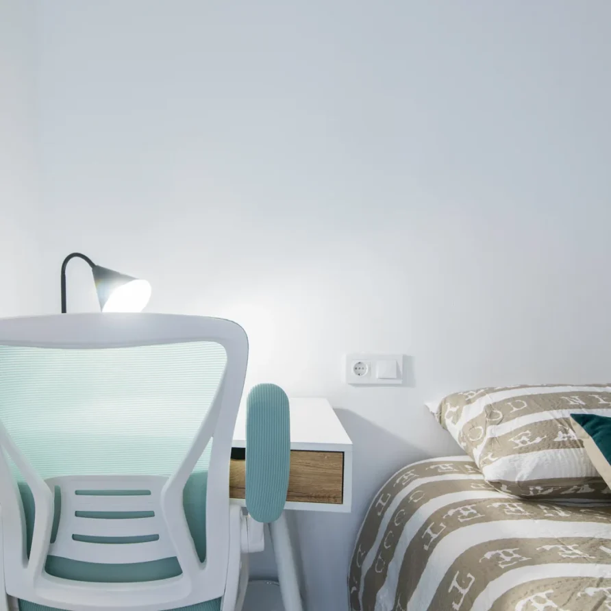 A minimalist bedroom with a desk
